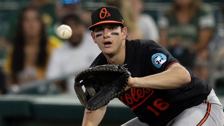 Jun 6, 2025; West Sacramento, California, USA; Athletics right fielder Lawrence Butler (4) scrambles back to first base as Baltimore Orioles first baseman Coby Mayo (16) fields the pickoff throw during the fifth inning at Sutter Health Park