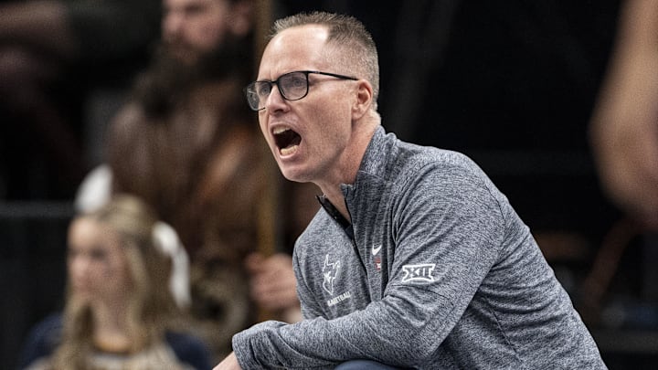 Mar 7, 2025; Kansas City, MO, USA; West Virginia Mountaineers head coach Mark Kellogg looks on from the sideline in the first quarter against the Kansas State Wildcats at T-Mobile Center. Mandatory Credit: Amy Kontras-Imagn Images