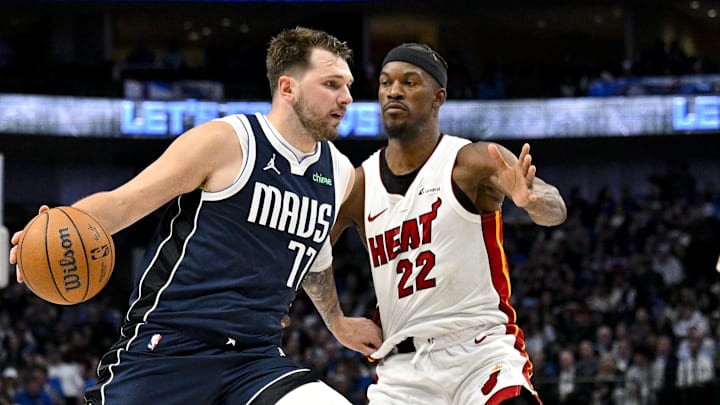 Mar 7, 2024; Dallas, Texas, USA; Dallas Mavericks guard Luka Doncic (77) looks the ball past Miami Heat forward Jimmy Butler (22) during the second half at the American Airlines Center. Mandatory Credit: Jerome Miron-Imagn Images