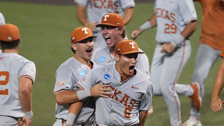 Texas Longhorns run on to the field to celebrate after closing out a Super Regional game over the Oregon Ducks. 