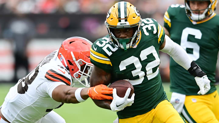 Aug 10, 2024; Cleveland, Ohio, USA; Green Bay Packers running back MarShawn Lloyd (32) runs with the ball as Cleveland Browns linebacker Caleb Johnson (48) defends during the second half at Cleveland Browns Stadium.