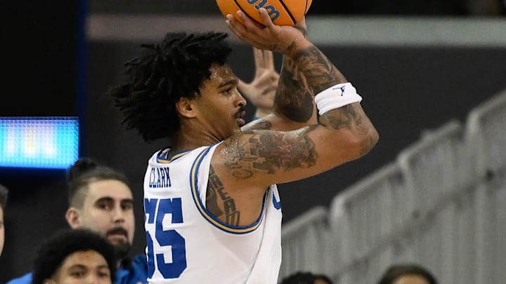 Mar 3, 2026; Los Angeles, California, USA; UCLA Bruins guard Skyy Clark (55) shoots over Nebraska Cornhuskers forward Pryce Sandfort (21) during the 2nd half at Pauley Pavilion presented by Wescom Financial. Left is UCLA Bruins head coach Mick Cronin. Mandatory Credit: Robert Hanashiro-Imagn Images