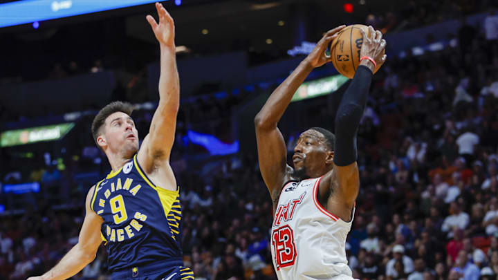 Feb 8, 2023; Miami, Florida, USA; Miami Heat center Bam Adebayo (13) grabs a rebound during the fourth quarter against Indiana Pacers guard T.J. McConnell (9) at Miami-Dade Arena. Mandatory Credit: Sam Navarro-Imagn Images