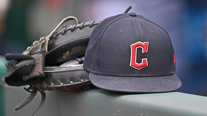 Jun 27, 2024; Kansas City, Missouri, USA; A general view a Cleveland Guardians hat and glove on the dugout railing before a game against the Kansas City Royals at Kauffman Stadium. Jun 27, 2024; Kansas City, Missouri, USA; A general view a Cleveland Guardians hat and glove on the dugout railing before a game against the Kansas City Royals at Kauffman Stadium.