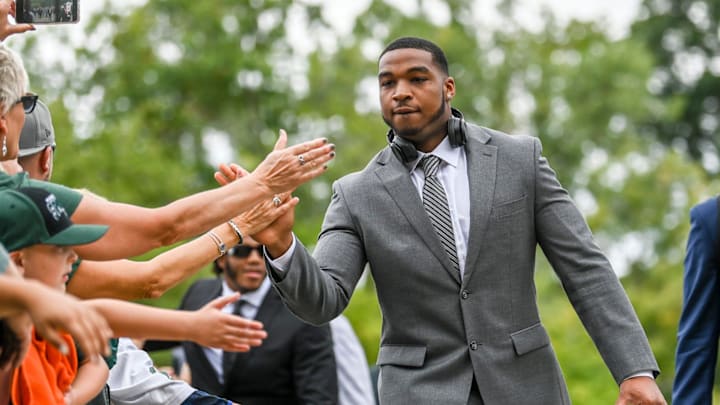 Michigan State's Jacoby Windmon slaps hands with fans while walking into Spartan Stadium ahead of the football game against Richmond on Saturday, Sept. 9, 2023, in East Lansing.