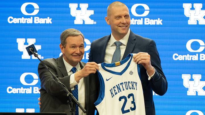 University of Kentucky Athletic Director Mitch Barnhart and new men’s basketball coach Mark Pope hold a new basketball jersey up during Pope’s press conference on Sunday, April 14, 2024. University of Kentucky Athletic Director Mitch Barnhart and new men’s basketball coach Mark Pope hold a new basketball jersey up during Pope’s press conference on Sunday, April 14, 2024.