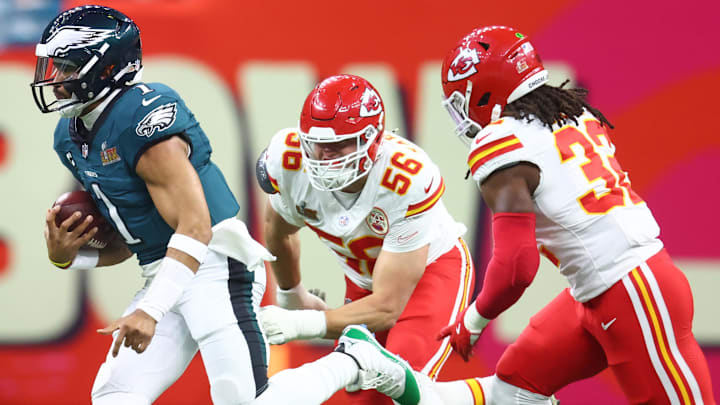 Philadelphia Eagles quarterback Jalen Hurts (1) runs the ball past Kansas City Chiefs defensive end George Karlaftis (56) in the first quarter in Super Bowl LIX at Caesars Superdome.