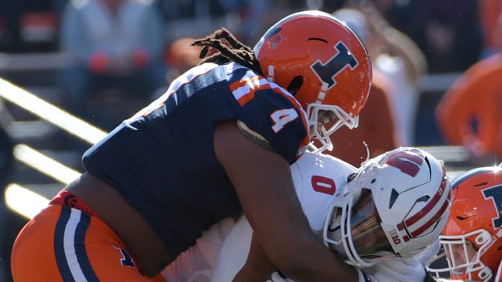 Oct 21, 2023; Champaign, Illinois, USA; Illinois Fighting Illini defensive tackle Jer'Zhan Newton (4) tackles Wisconsin Badgers running back Braelon Allen (0) during the first half at Memorial Stadium. 