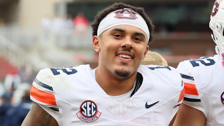 Oct 25, 2025; Fayetteville, Arkansas, USA; Auburn Tigers quarterback Ashton Daniels (12) celebrates after the game against the Arkansas Razorbacks at Donald W. Reynolds Razorback Stadium. Auburn won 33-24. Mandatory Credit: Nelson Chenault-Imagn Images