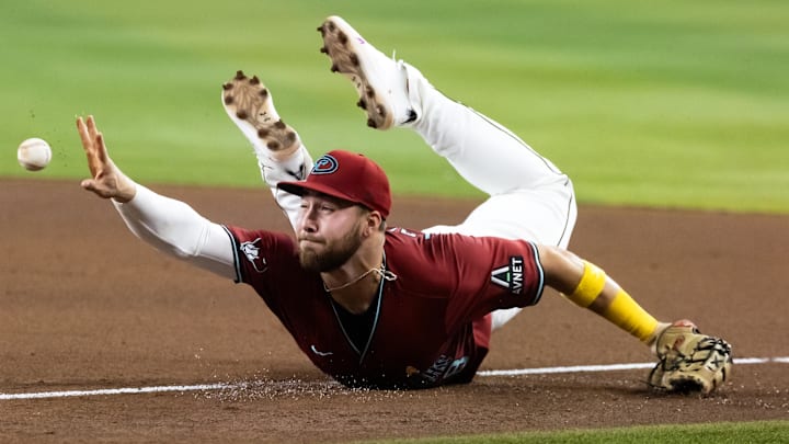 Sep 7, 2025; Phoenix, Arizona, USA; Arizona Diamondbacks first baseman Tyler Locklear fields a ball for an out against the Boston Red Sox in the seventh inning at Chase Field. Mandatory Credit: Mark J. Rebilas-Imagn Images