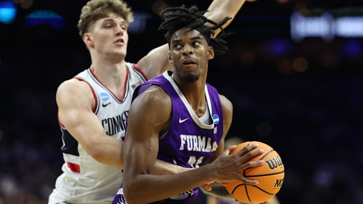 Furman Paladins forward Cooper Bowser (21) dribbles the ball against the UConn Huskies in the second half during a first round game of the men's 2026 NCAA Tournament at Xfinity Mobile Arena. Furman Paladins forward Cooper Bowser (21) dribbles the ball against the UConn Huskies in the second half during a first round game of the men's 2026 NCAA Tournament at Xfinity Mobile Arena.