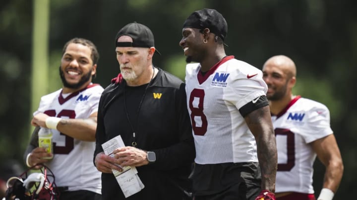 Washington Commanders running backs Brian Robinson (center), Austin Ekeler (right), and Chris Rodriguez Jr. (left) with head coach Dan Quinn.