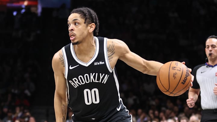 Mar 10, 2026; Brooklyn, New York, USA;  Brooklyn Nets forward Josh Minott (00) looks to drive past Detroit Pistons guard Marcus Sasser (25) in the second quarter at Barclays Center. Mandatory Credit: Wendell Cruz-Imagn Images