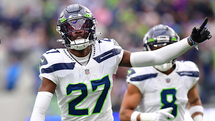 Dec 4, 2022; Inglewood, California, USA; Seattle Seahawks cornerback Tariq Woolen (27) celebrates after intercepting a pass intended for Los Angeles Rams running back Kyren Williams (23) during the first half at SoFi Stadium. Mandatory Credit: Gary A. Vasquez-Imagn Images