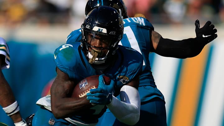 Jacksonville Jaguars running back Tank Bigsby (4) rushes for yards against Green Bay Packers safety Xavier McKinney (29) during the fourth quarter of an NFL football matchup Sunday, Oct. 27, 2024 at EverBank Stadium in Jacksonville, Fla. The Packers edged the Jaguars 30-27 on a last-second field goal. [Corey Perrine/Florida Times-Union]