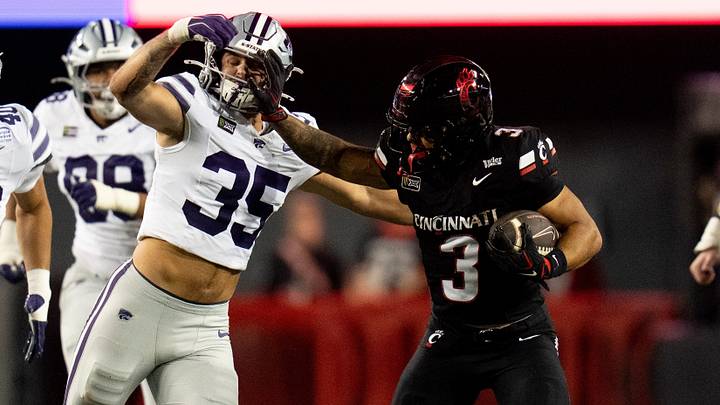 Cincinnati Bearcats running back Cole Tabb (3) stiff arms Kansas State Wildcats linebacker Gabe Powers (35) in the second quarter of the NCAA football game between the Cincinnati Bearcats and Kansas State Wildcats at Nippert Stadium in Cincinnati on Saturday, September 26, 2026. Cincinnati Bearcats running back Cole Tabb (3) stiff arms Kansas State Wildcats linebacker Gabe Powers (35) in the second quarter of the NCAA football game between the Cincinnati Bearcats and Kansas State Wildcats at Nippert Stadium in Cincinnati on Saturday, September 26, 2026.