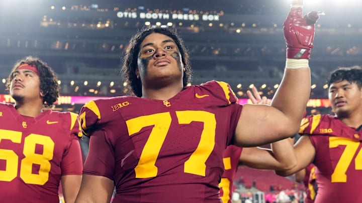 Oct 25, 2024; Los Angeles, California, USA; Southern California Trojans offensive lineman Alani Noa (77) celebrates with teammates after the game against the Rutgers Scarlet Knights at United Airlines Field at Los Angeles Memorial Coliseum. Mandatory Credit: Kirby Lee-Imagn Images Oct 25, 2024; Los Angeles, California, USA; Southern California Trojans offensive lineman Alani Noa (77) celebrates with teammates after the game against the Rutgers Scarlet Knights at United Airlines Field at Los Angeles Memorial Coliseum. Mandatory Credit: Kirby Lee-Imagn Images