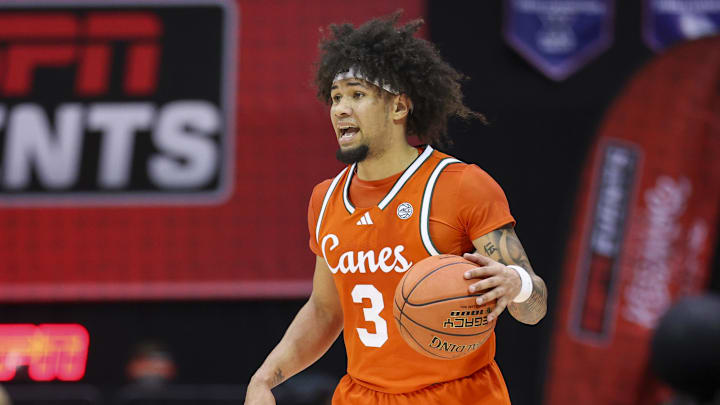 Nov 27, 2025; Kissimmee, Florida, USA; Miami (FL) Hurricanes guard Tre Donaldson (3) controls the ball against the Brigham Young University Cougars in the first half at State Farm Field House. Mandatory Credit: Nathan Ray Seebeck-Imagn Images