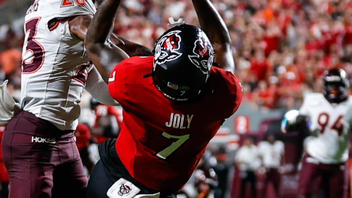 Sep 27, 2025; Raleigh, North Carolina, USA; North Carolina State Wolfpack tight end Justin Joly (7) catches a pass, past Virginia Tech Hokies cornerback Thomas Williams (23) during the first half of the game at Carter-Finley Stadium. Mandatory Credit: Jaylynn Nash-Imagn Images