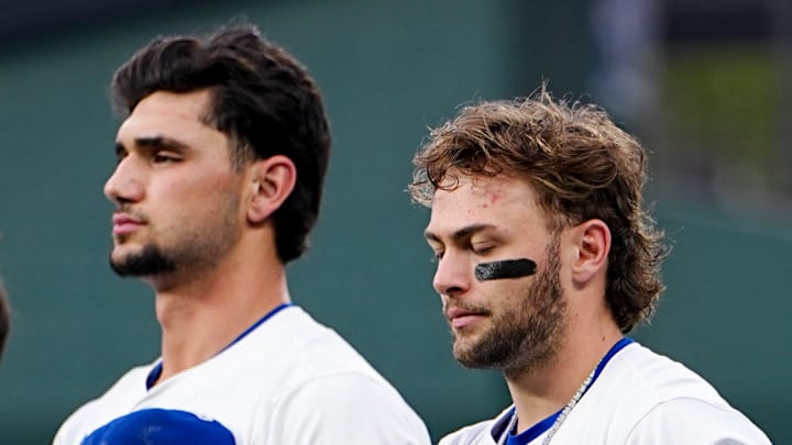 Jac Caglianone and Carter Jensen take a moment of silence during the National Anthem in a game versus the Seattle Mariners in September of 2025.