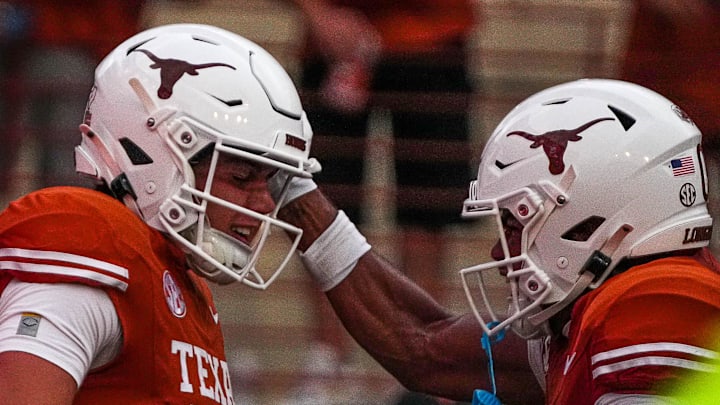 Sep 14, 2024; Austin, Texas, USA; Texas Longhorns quarterback Arch Manning (16) and receiver DeAndre Moore Jr. (0) celebrate a touchdown by Manning during the game against UTSA at Darrell K Royal–Texas Memorial Stadium. Mandatory Credit: Aaron E. Martinez/USA TODAY Network via Imagn Images