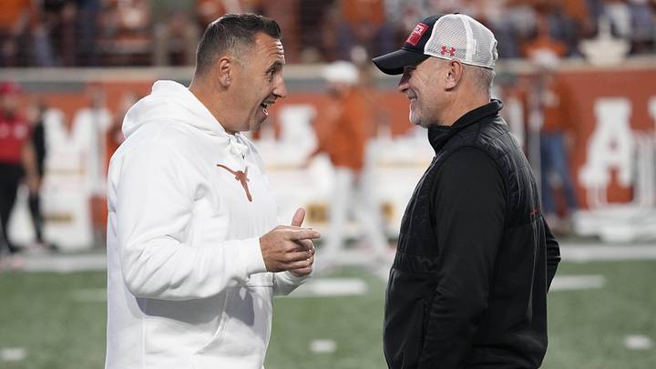 Texas Longhorns head coach Steve Sarkisian talks with Texas Tech Red Raiders head coach Joey McGuire before the game at Darrell K Royal-Texas Memorial Stadium.