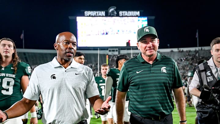 Michigan State football coach Jonathan Smith, right, talks with athletic director Alan Haller after MSU's victory over Florida Atlantic on Friday, Aug. 30, 2024, at Spartan Stadium in East Lansing.