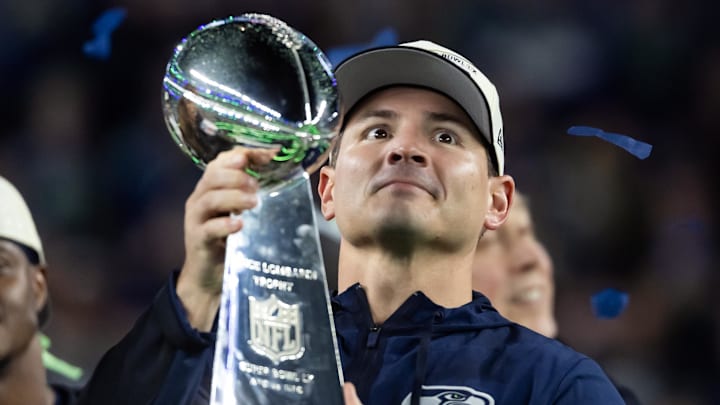 Feb 8, 2026; Santa Clara, CA, USA; Seattle Seahawks head coach Mike MacDonald celebrates with the Vince Lombardi trophy on the podium after defeating the New England Patriots in Super Bowl LX at Levi's Stadium. Mandatory Credit: Mark J. Rebilas-Imagn Images