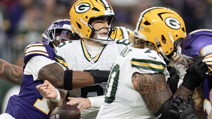 Green Bay Packers quarterback Clayton Tune is sacked and stripped by Minnesota Vikings linebacker Dallas Turner.