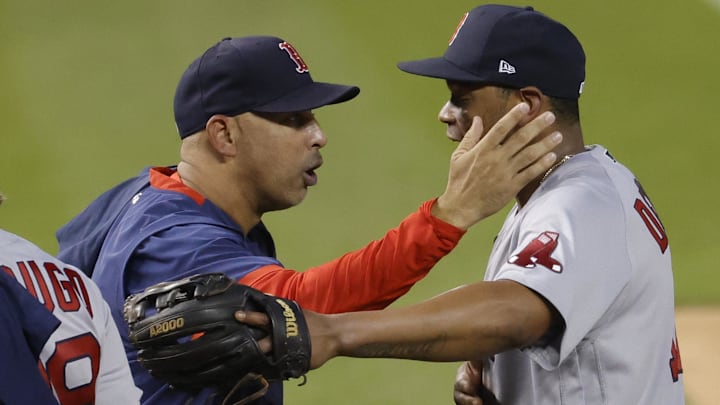 Boston Red Sox manager Alex Cora (L) celebrates with Rafael Devers (11) after clinching a Wild Card berth after their game against the Washington Nationals at Nationals Park.