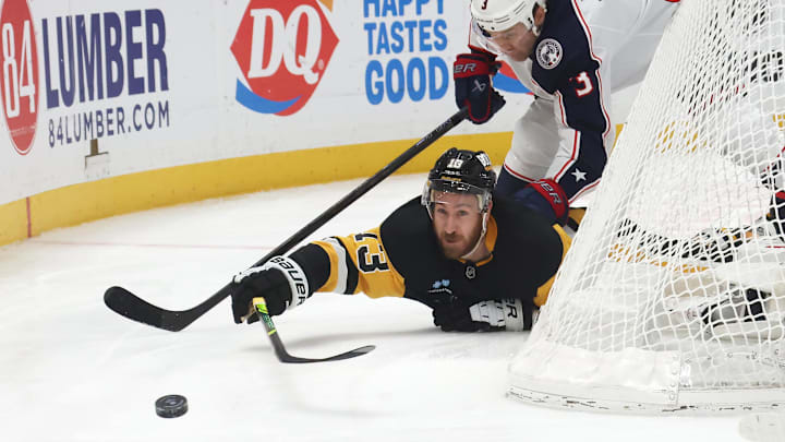 Mar 21, 2025; Pittsburgh, Pennsylvania, USA;  Pittsburgh Penguins right wing Kevin Hayes (13) pushes the puck away from Columbus Blue Jackets defenseman Jack Johnson (3) during the third period at PPG Paints Arena. Mandatory Credit: Charles LeClaire-Imagn Images
