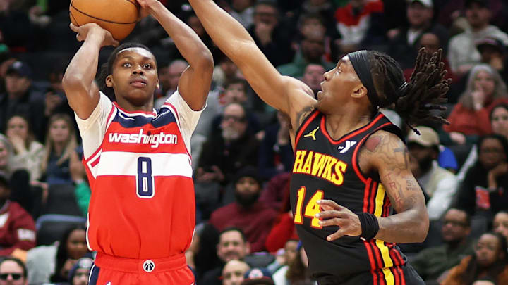 Feb 8, 2025; Washington, District of Columbia, USA; Washington Wizards guard Bub Carrington (8) takes a shot over Atlanta Hawks guard Terance Mann (14) during the second half at Capital One Arena. Mandatory Credit: Daniel Kucin Jr.-Imagn Images