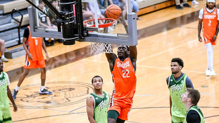Team Snipes and Michigan State's Trey Fort dunks against Team Faygo during the Moneyball Pro-Am on Thursday, June 26, 2025, at Holt High School.
