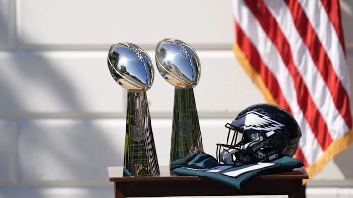 Two Vince Lombardi Trophies, a helmet and jersey on a table before President Donald Trump honors the Super Bowl LIX champion Philadelphia Eagles at The White House in Washington D.C., on April 28, 2025.