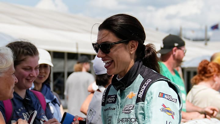 NASCAR Xfinity Series driver Katherine Legge (32) signs autographs with fans Saturday, July 26, 2025, prior to the Pennzoil 250 at Indianapolis Motor Speedway.