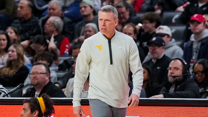 Feb 5, 2026; Cincinnati, Ohio, USA;  West Virginia Mountaineers head coach Ross Hodge works the sideline against the Cincinnati Bearcats in the first half at Fifth Third Arena. Mandatory Credit: Aaron Doster-Imagn Images
