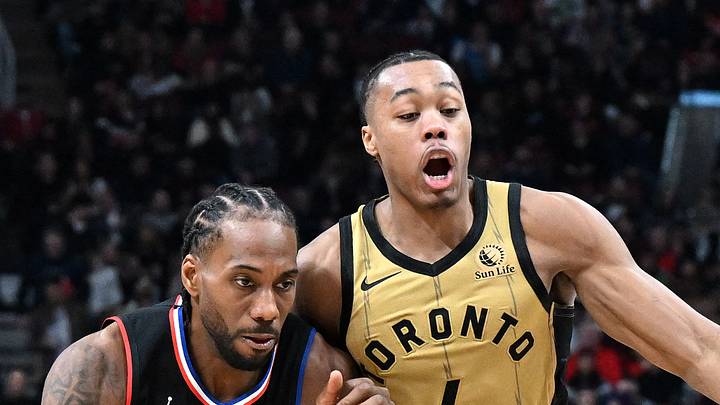 Kawhi Leonard dribbles the ball against Toronto Raptors forward Scottie Barnes. Kawhi Leonard dribbles the ball against Toronto Raptors forward Scottie Barnes.