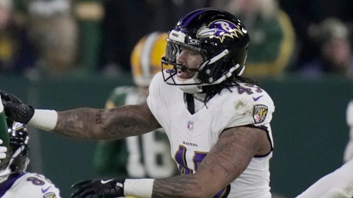 Green Bay Packers linebacker Ty'Ron Hopper (59) exchanges shoves with Baltimore Ravens linebacker Mike Green (45) during the second quarter of their game Saturday, December 27, 2025 at Lambeau Field in Green Bay, Wisconsin.