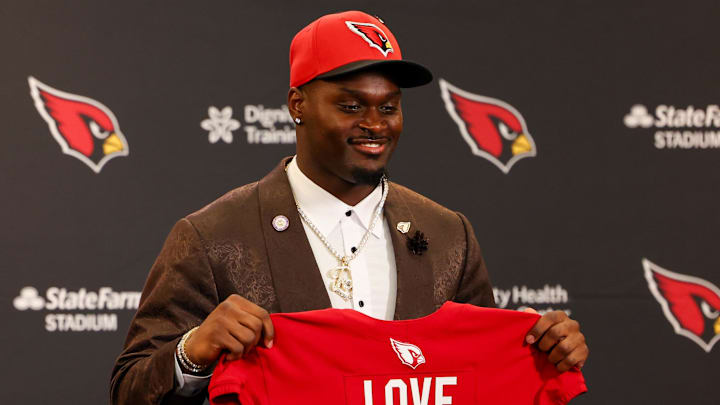 Apr 24, 2026; Phoenix, AZ, USA; Arizona Cardinals first-round draft pick Jeremiyah Love poses with his jersey during a press conference at Dignity Health Arizona Cardinals Training Center. Mandatory Credit: Anna Carrington-Imagn Images