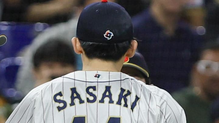 Mar 20, 2023; Miami, Florida, USA; Japan starting pitcher Roki Sasaki (14) celebrates with teammates after the first inning against Mexico at LoanDepot Park