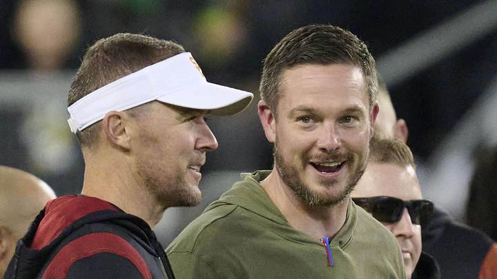 Nov 11, 2023; Eugene, Oregon, USA; USC Trojans head coach Lincoln Riley, left, and Oregon Ducks head coach Dan Lanning talk before a game at Autzen Stadium. Mandatory Credit: Troy Wayrynen-Imagn Images