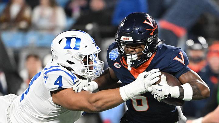 Virginia Cavaliers wide receiver Cam Ross (6) runs the ball while defended by Duke Blue Devils defensive tackle Josiah Green 