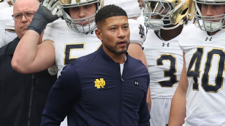 Nov 15, 2025; Pittsburgh, Pennsylvania, USA; Notre Dame Fighting Irish head coach Marcus Freeman (middle) leads the team onto the field to play the Pittsburgh Panthers at Acrisure Stadium. Nov 15, 2025; Pittsburgh, Pennsylvania, USA; Notre Dame Fighting Irish head coach Marcus Freeman (middle) leads the team onto the field to play the Pittsburgh Panthers at Acrisure Stadium.