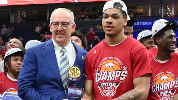 Arkansas point guard Darius Acuff Jr. receives his tournament MVP trophy from SEC president Greg Sankey after the Hogs won the men's SEC Conference Tournament Championship against the Vanderbilt Commodores at Bridgestone Arena Sunday.