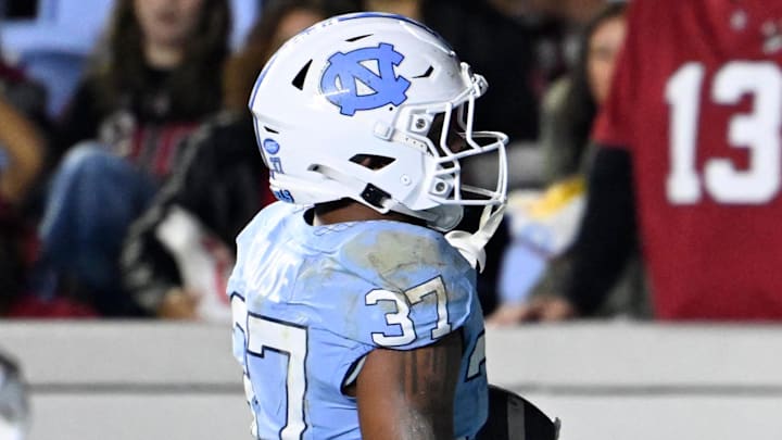 Nov 8, 2025; Chapel Hill, North Carolina, USA; North Carolina Tar Heels running back Davion Gause (37) scores a touchdown as Stanford Cardinal cornerback Collin Wright (6) defends in the third quarter at Kenan Stadium. Mandatory Credit: Bob Donnan-Imagn Images