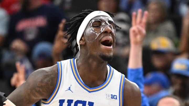Dec 28, 2024; Inglewood, California, USA; UCLA Bruins guard Eric Dailey Jr. (3) celebrates hitting a 3-point jumper during the second half against the Gonzaga Bulldogs at Intuit Dome. Left is Gonzaga Bulldogs forward Ben Gregg (33). Mandatory Credit: Robert Hanashiro-Imagn Images