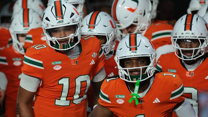 Oct 17, 2026; Miami Gardens, Florida, USA;  Miami Hurricanes quarterback Darian Mensah (10), wide receiver Malachi Toney (1) and teammates take the field before a game against the Florida State Seminoles at Hard Rock Stadium.  Mandatory Credit: Sam Navarro-Imagn Images