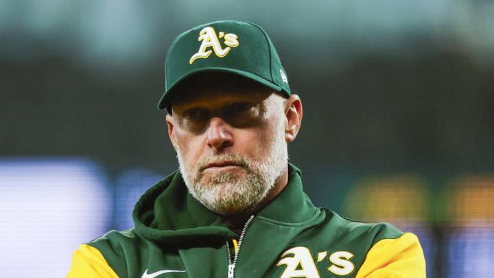 Apr 22, 2026; Seattle, Washington, USA; Athletics manager Mark Kotsay (7) talks with staff in the dugout following a batted ball that was trapped in the jersey of Seattle Mariners starting pitcher Logan Gilbert (36, not pictured) during the first inning at T-Mobile Park. The play was ruled a hit. Mandatory Credit: Joe Nicholson-Imagn Images Apr 22, 2026; Seattle, Washington, USA; Athletics manager Mark Kotsay (7) talks with staff in the dugout following a batted ball that was trapped in the jersey of Seattle Mariners starting pitcher Logan Gilbert (36, not pictured) during the first inning at T-Mobile Park. The play was ruled a hit. Mandatory Credit: Joe Nicholson-Imagn Images