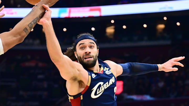 Mar 27, 2026; Cleveland, Ohio, USA; Miami Heat guard Norman Powell (24) goes for a loose ball against Cleveland Cavaliers guard Max Strus (2) during the second half at Rocket Arena. Mandatory Credit: Ken Blaze-Imagn Images