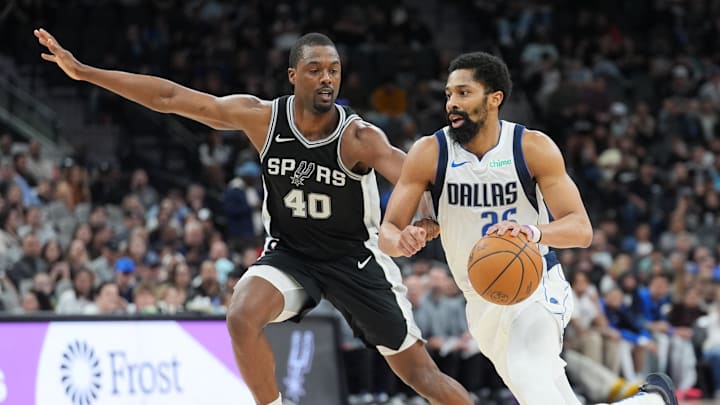 Mar 10, 2025; San Antonio, Texas, USA;  Dallas Mavericks guard Spencer Dinwiddie (26) dribbles against San Antonio Spurs forward Harrison Barnes (40) in the second half at Frost Bank Center. Mandatory Credit: Daniel Dunn-Imagn Images